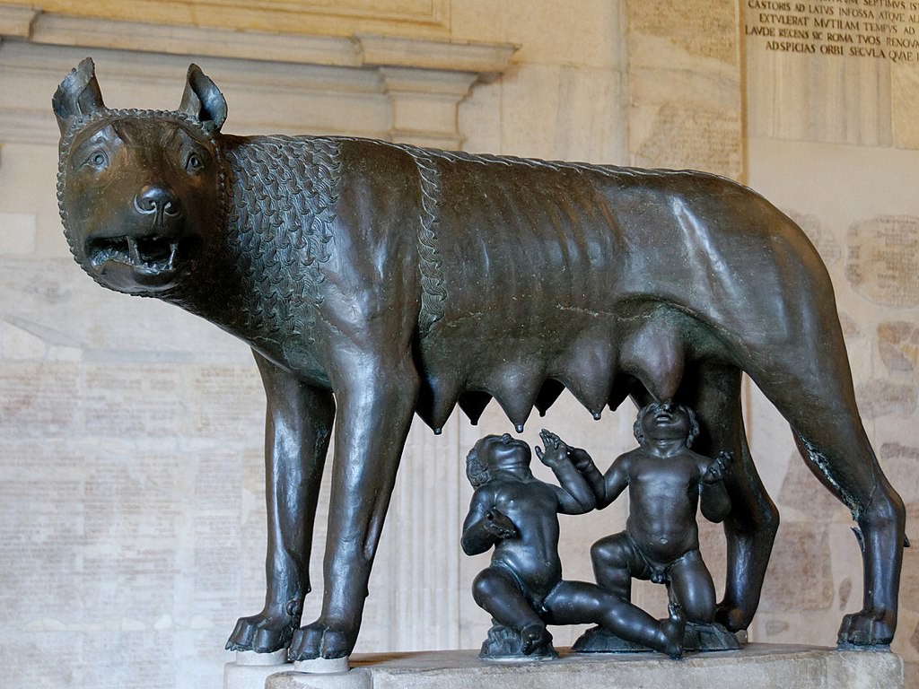 A bronze statue of a female wolf nursing two human babies.