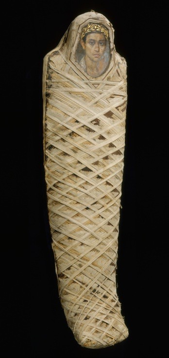A wrapped mummy with a realistically painted face of a young man wearing a gold civic crown. The image is on wood, in place of an ancient Egyptian mask.