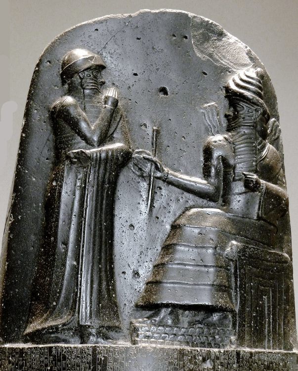 A bearded figure sits in a throne while another figure stands before him.