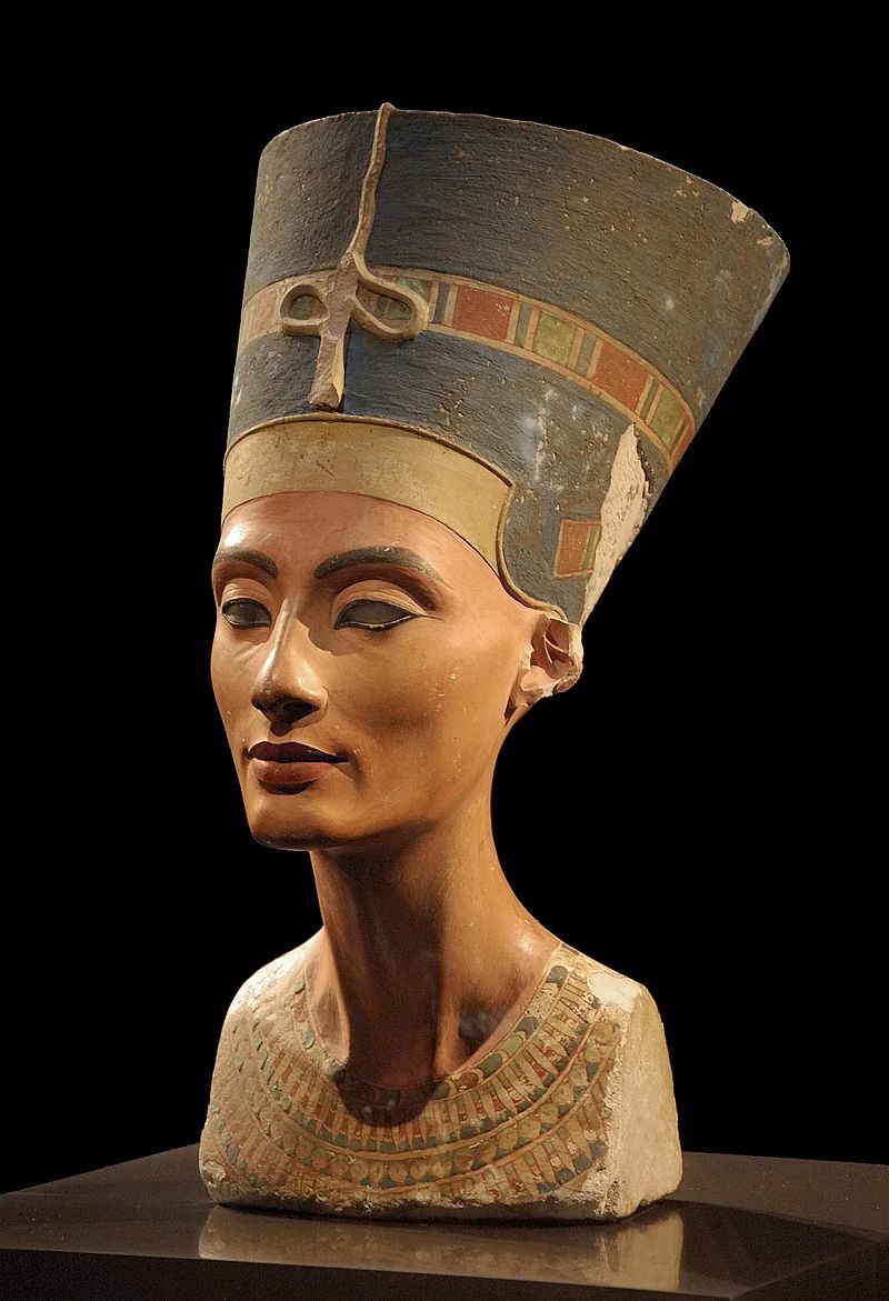 A nearly finished bust of the Middle Kingdom queen, Nefertiti. She was believed to be the most beautiful woman in the world. The unfinished bust of the queen Nefertiti. She is painted and beautifully carved. She wears her ceremonial necklace and a crown.