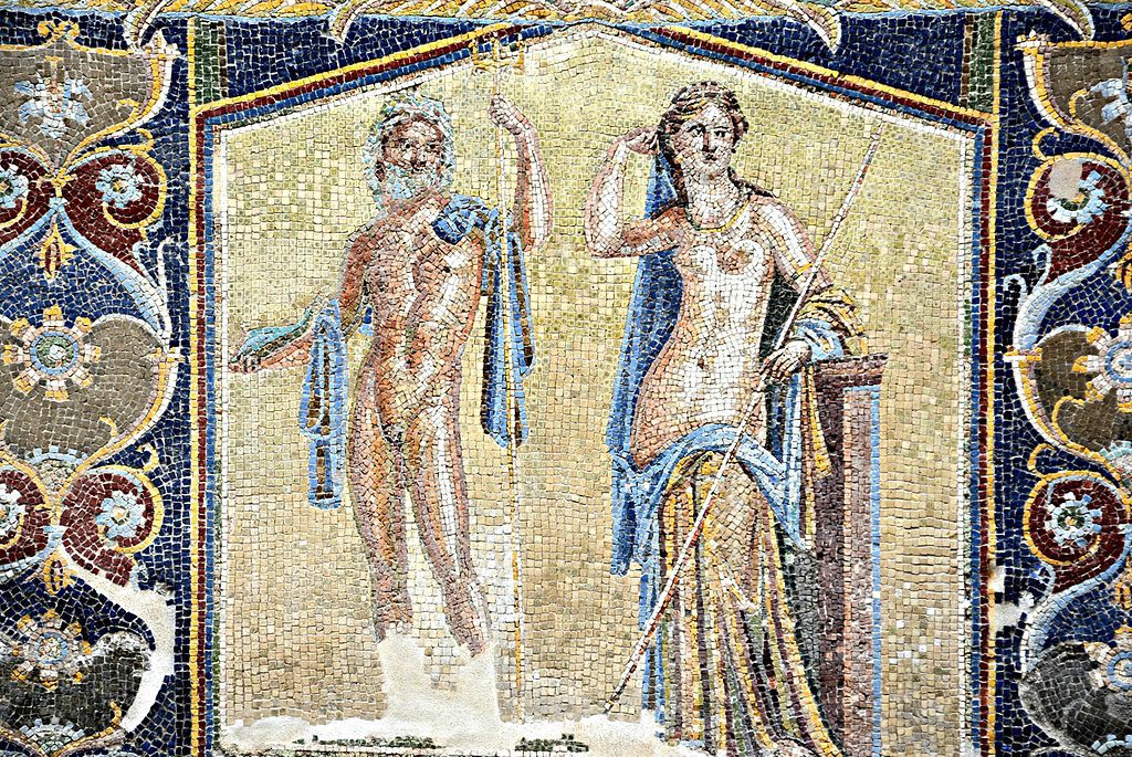 A mosaic of a nude bearded man with a blue cloth draped over his arms. He stands next to a woman who is clothed from below her navel down. He holds a trident, and she holds a spear. They stand against a gold background, which is surrounded by colorful geometric designs.