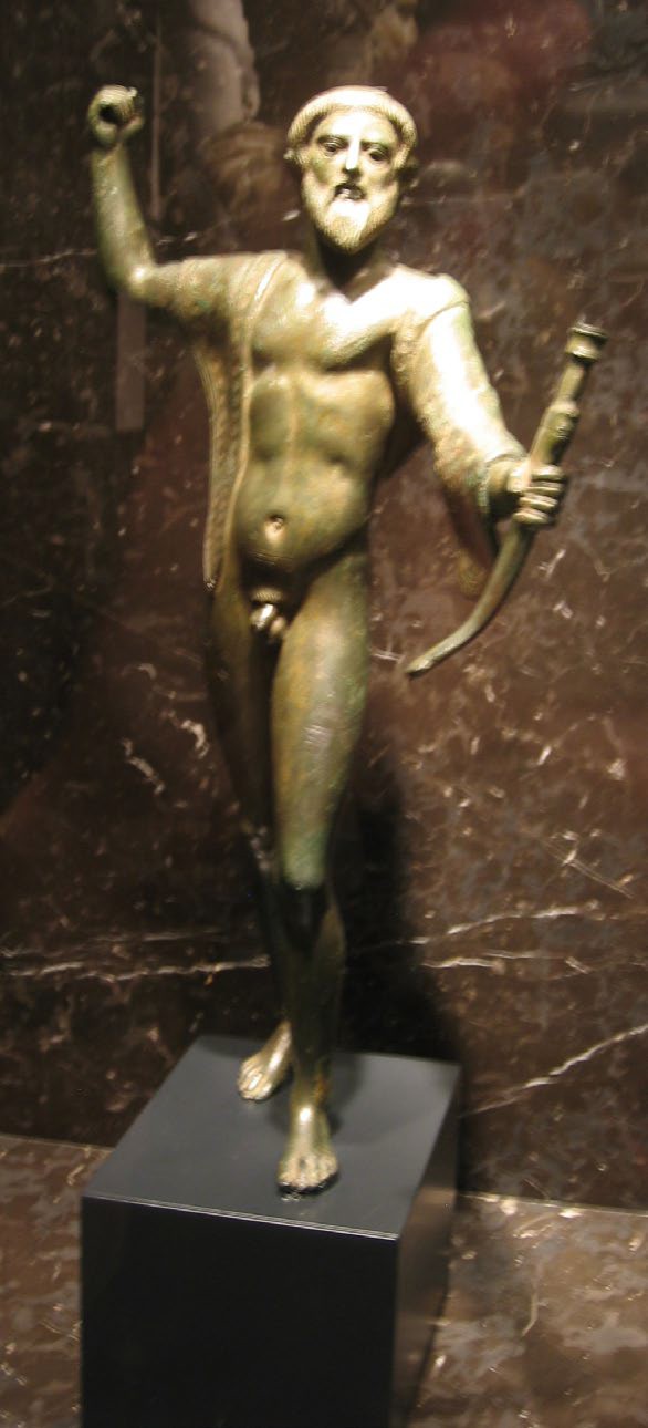A bronze, nude man with a bow in his left hand and his right hand raised behind him. He has a pointed beard.