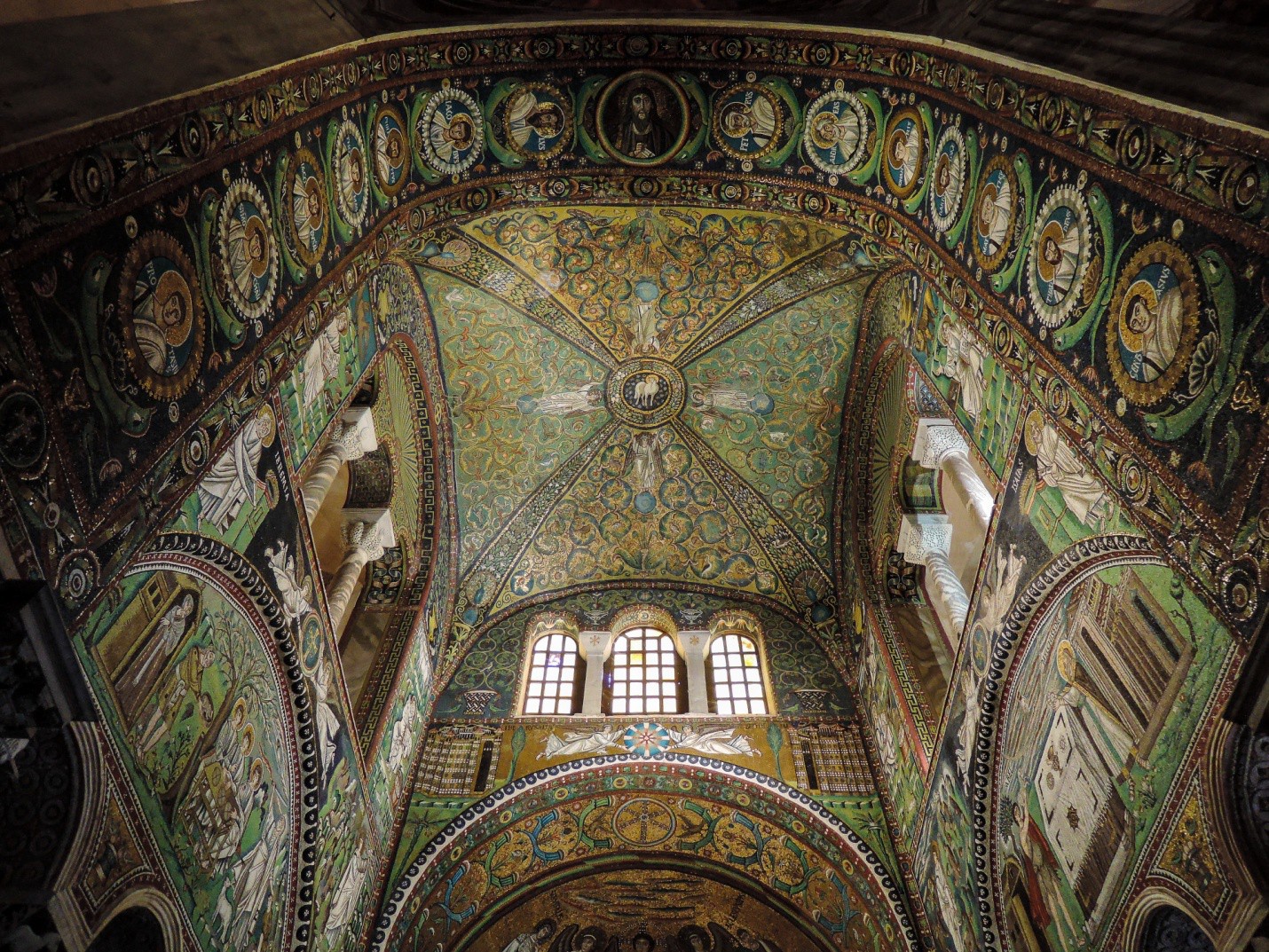 The elaborately decorated triumphal arch that leads to the apse. The entire apse is covered in colorful mosaics.