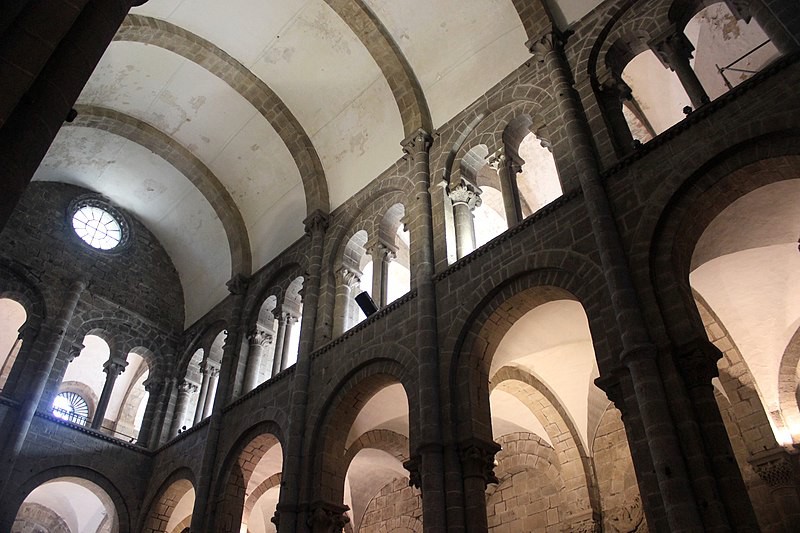 A view of the barrel vault ceiling, light coming in through the clerestory windows and through the side aisle.