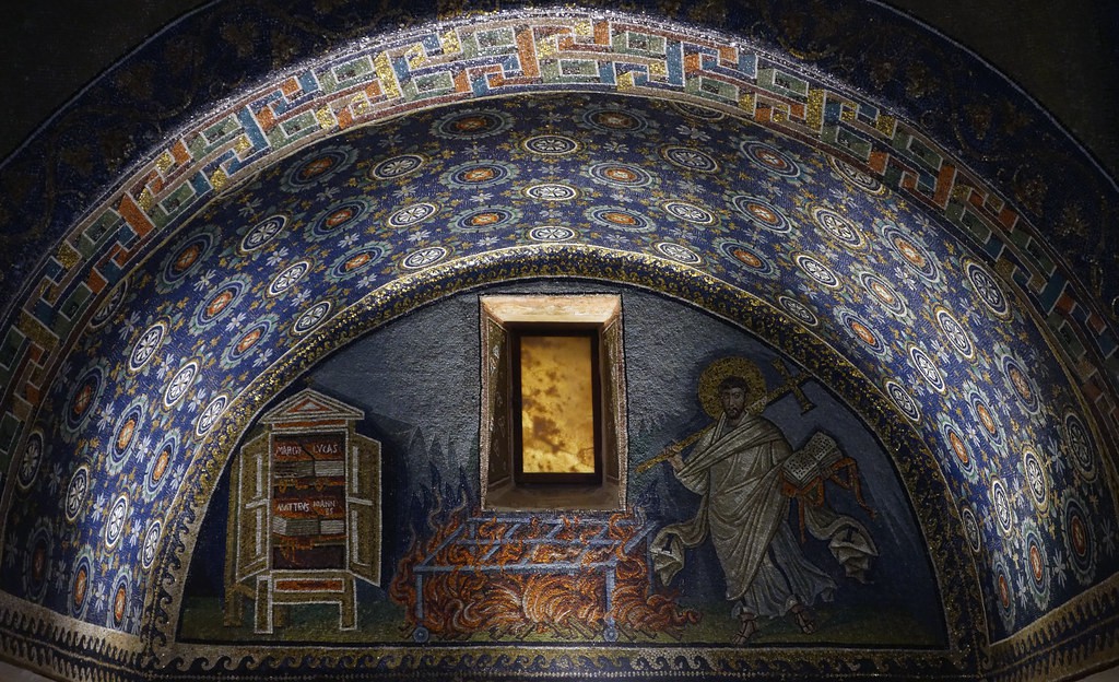 A close-up view of Laurence’s sacrifice. A window above the gridiron is made of alabaster, creating the look of fire outside it.