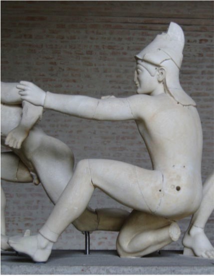 An archer kneeling on one knee with the other leg resting on its heel.