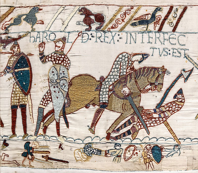Harold is depicted with an arrow in his eye. Others surround him in chain mail, holding shields.