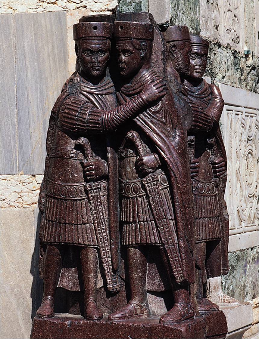 A Closer view of the sculpture that reveals the figures holding each other as each puts a hand on his sword.