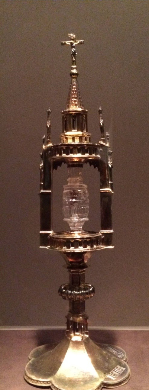 A silver and crystal container with a tooth in it.