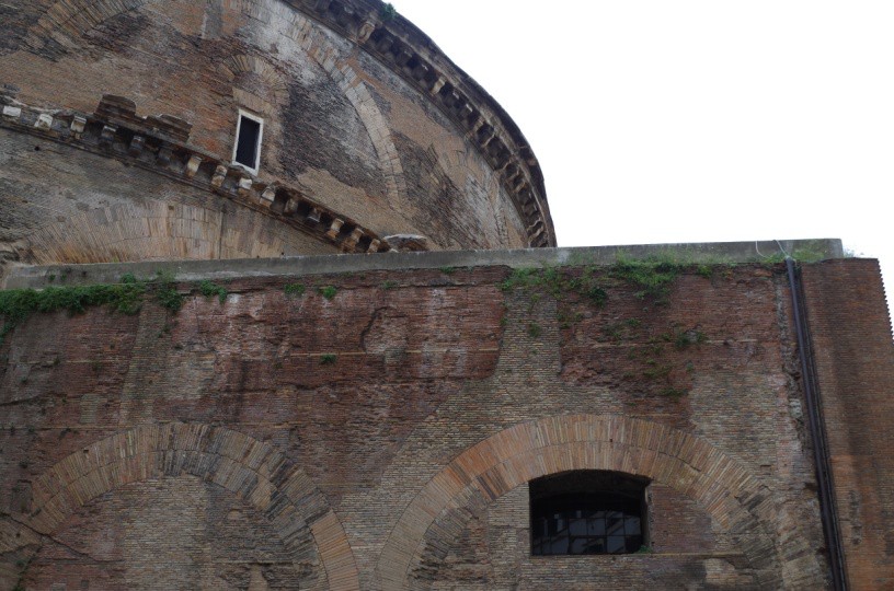 An exterior photo of the building that reveals arches integrated into the walls for added strength.