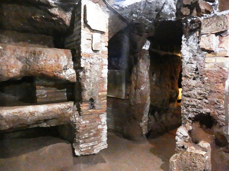 An underground cave with shelves carved and built with bricks.