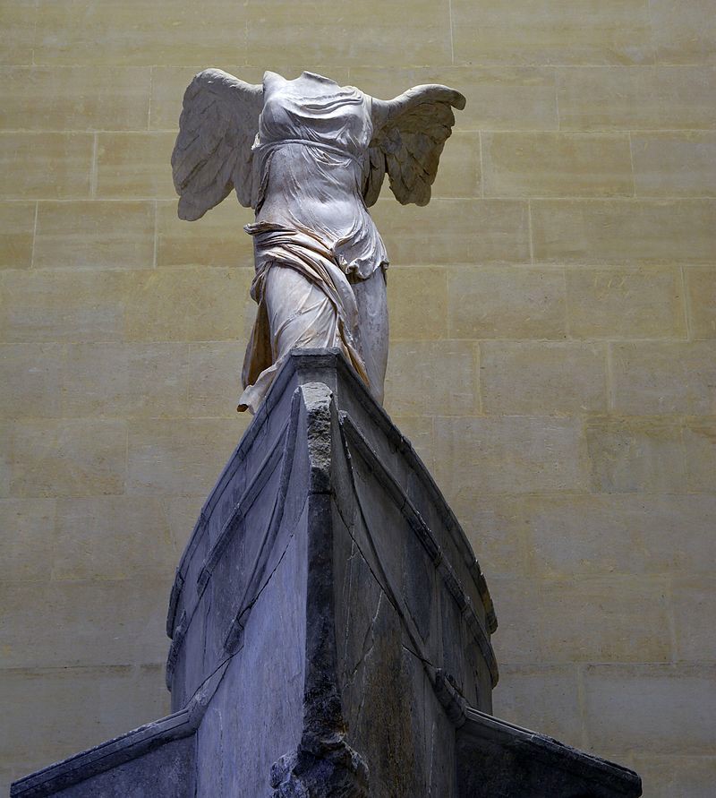 The figure’s clothing reveals her body by emphasizing the navel and muscles of the stomach. Refer to the text for details.