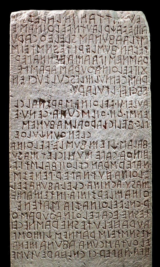 A stone tablet inscribed with Etruscan letters.