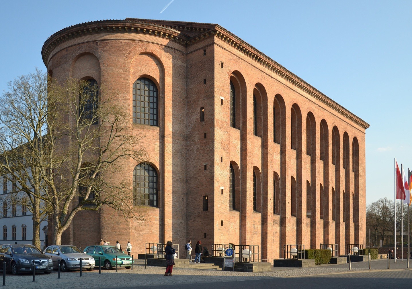 A two-story brick building with an apse and arched windows.