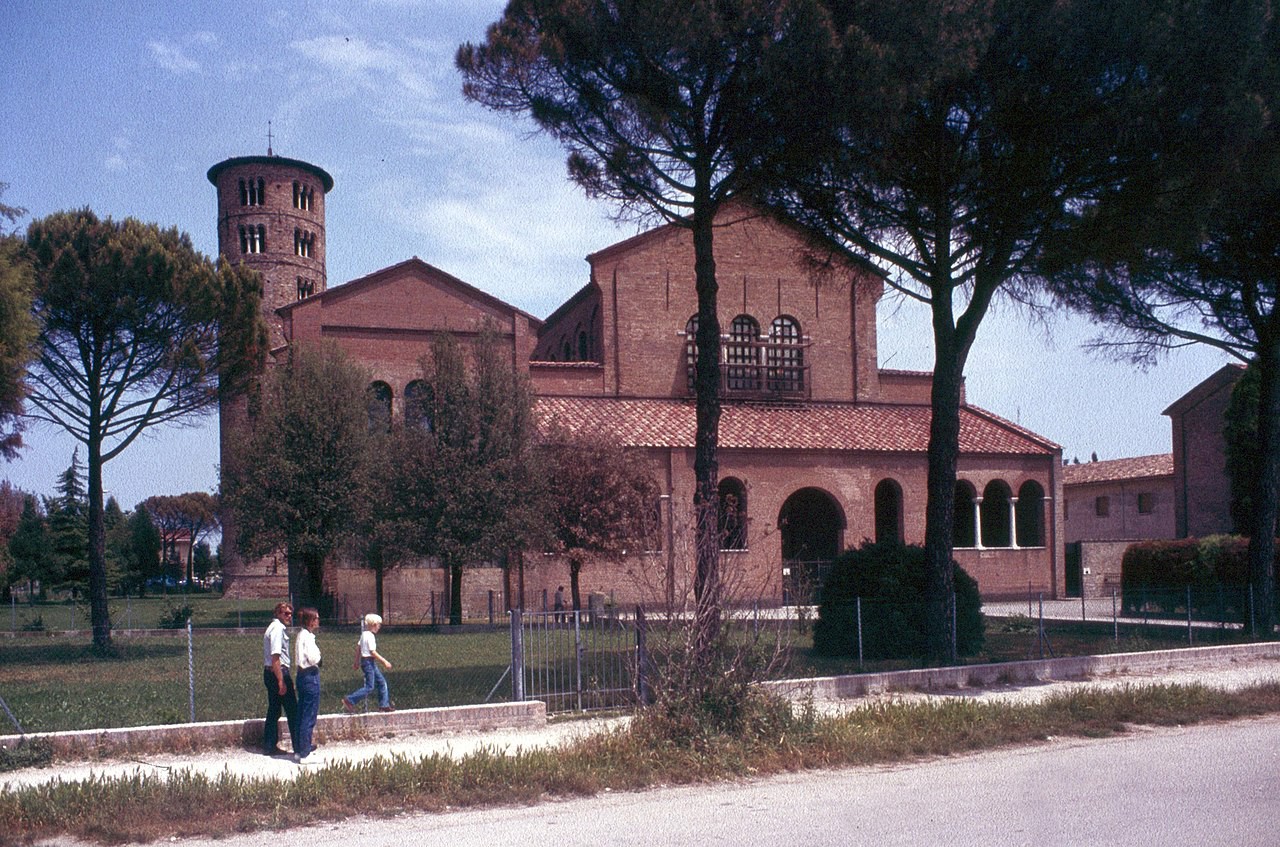 Brick church with a covered porch and tower.