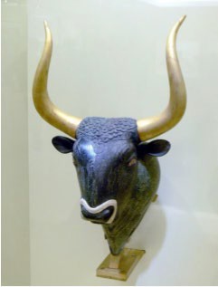 Dark, realistic bull’s head with gold horns.