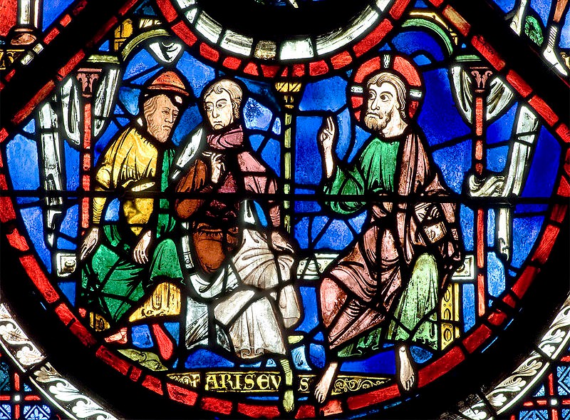Jesus, with his halo speaks to two men who are seated beside him.