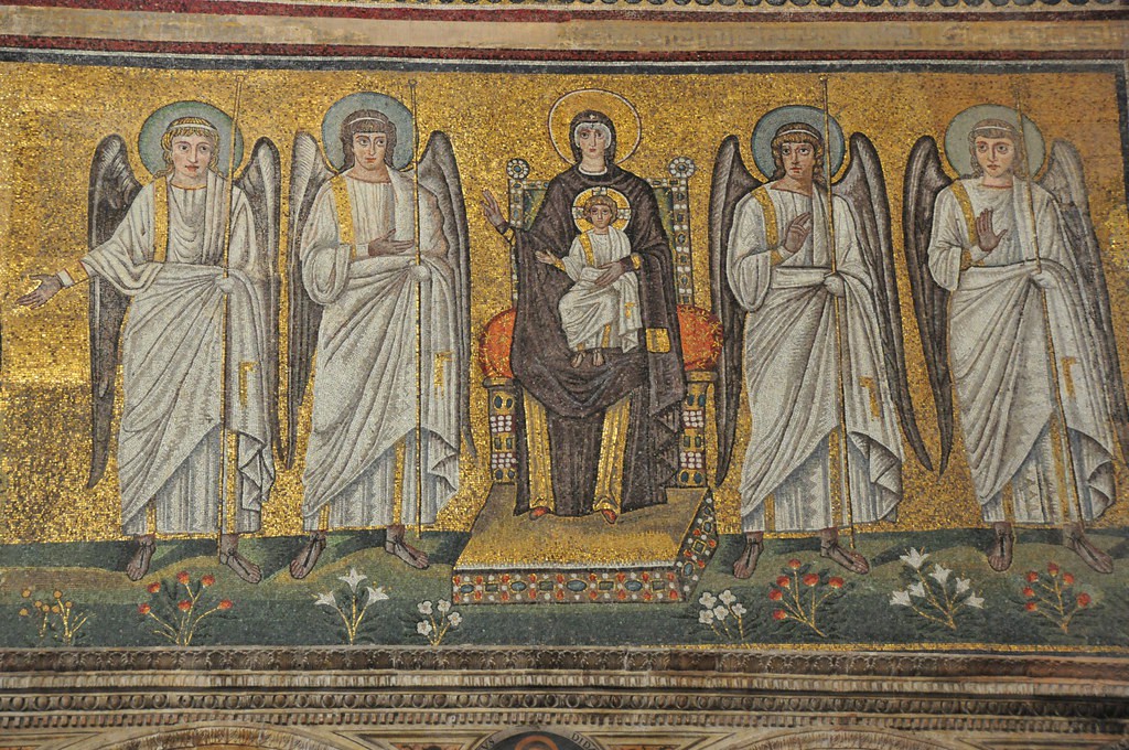 Mary on a throne with the baby Jesus on her lap. Two angels stand on each side of her.