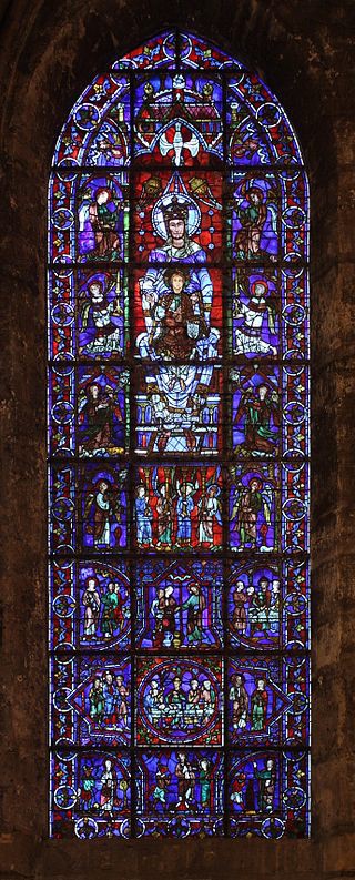 A lancet window that has twenty-four sections. The top image of this window is of the dove hovering over the head of Mary who holds the Christ-child on her lap.