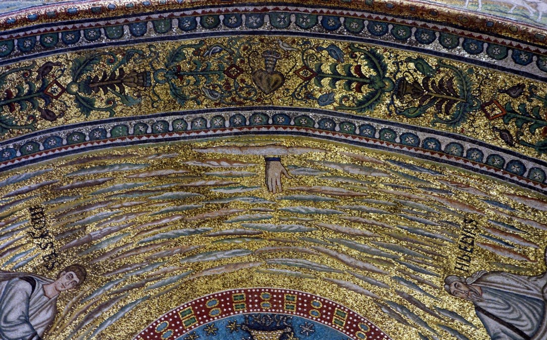 A hand reaches through the clouds toward the medallion with the Cross in it.