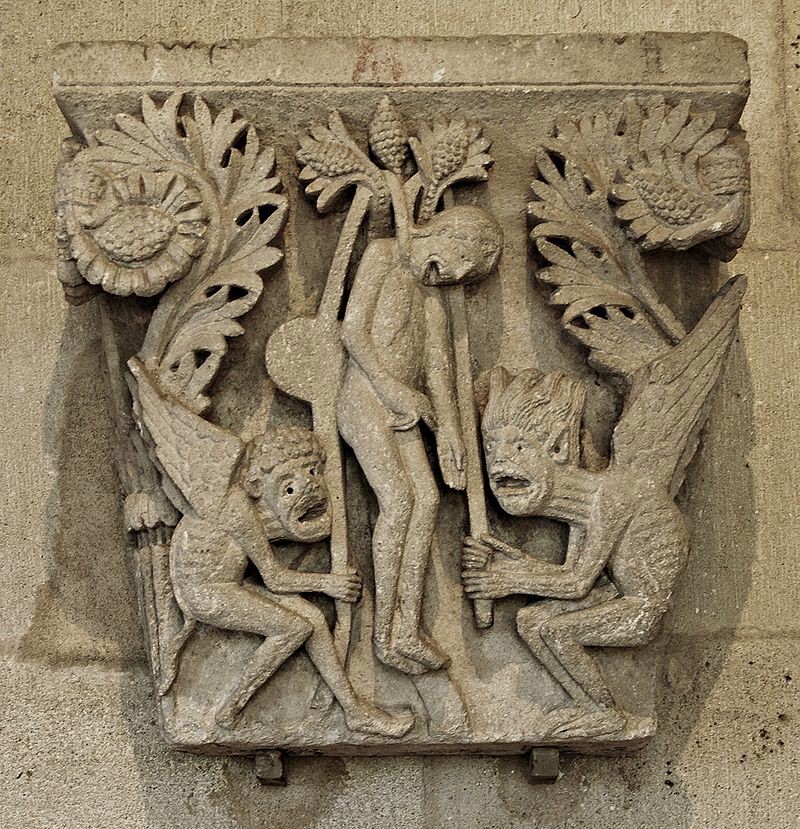 Capital carving of judas being helped to his suicide. Refer to the text for details.