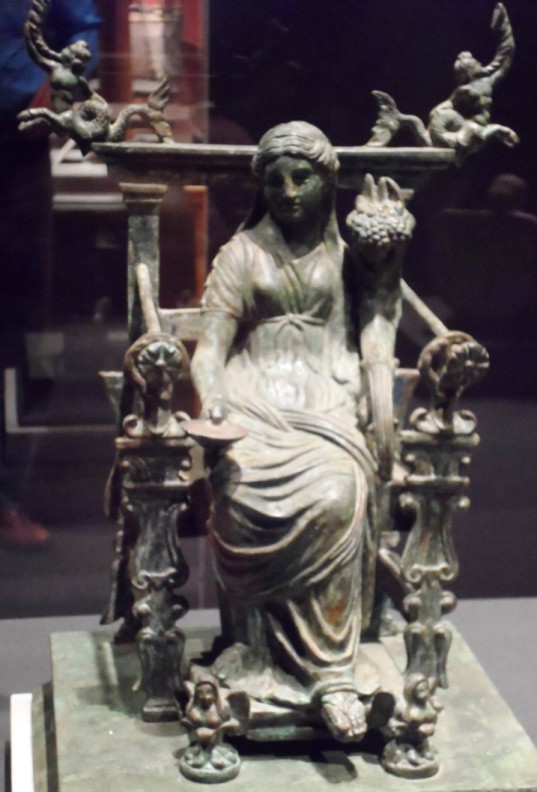 A cast figure of Fortuna seated on an elaborate throne.