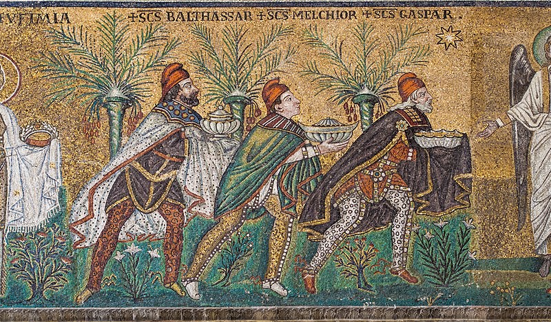 A close-up of the wise men against a gold background. There are stylized palm trees behind them and lush vegetation below their feet.