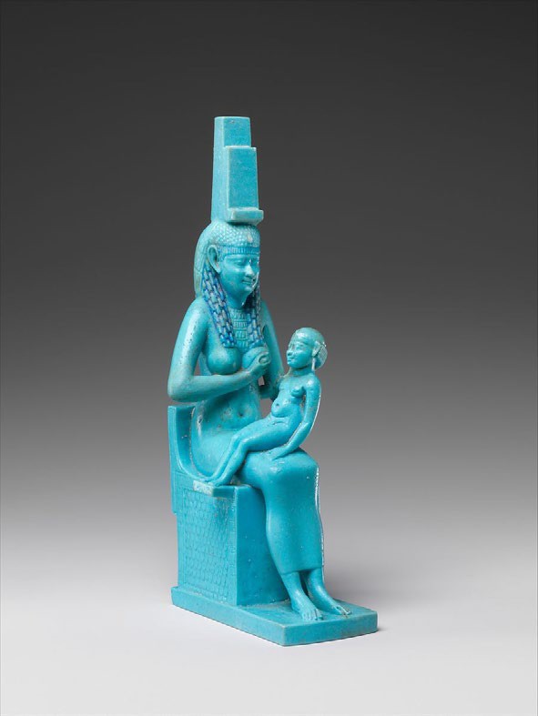 A small, stylized statue of a crowned Isis seated and breastfeeding her child. She may be carved from turquoise or amazonite.