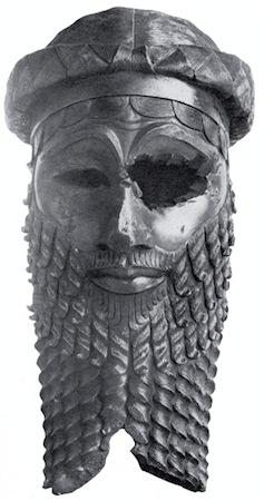 Three views of a bronze head. The face and beard are stylized in an ideal manner. Although there are no longer eyes, one eye socket is seriously damaged.