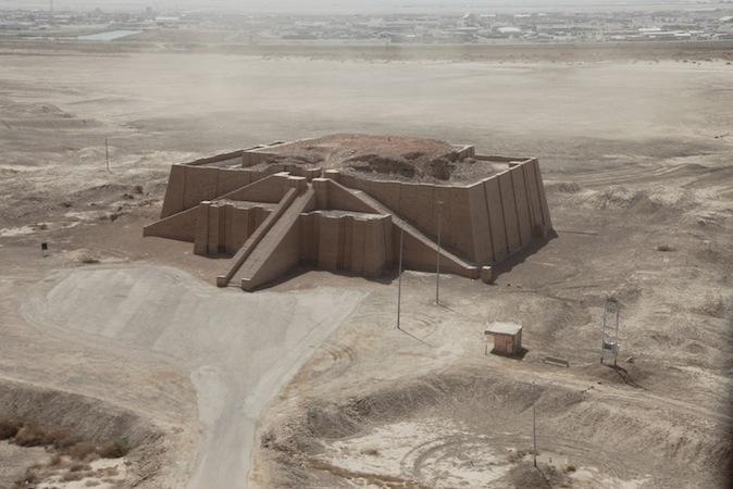 A large, solid building with three visible ramps and walls that tilt inward as they rise.