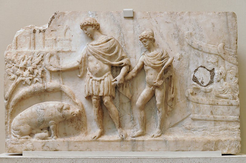 A marble bas relief of a clothed man and a boy in a cape with a pig.