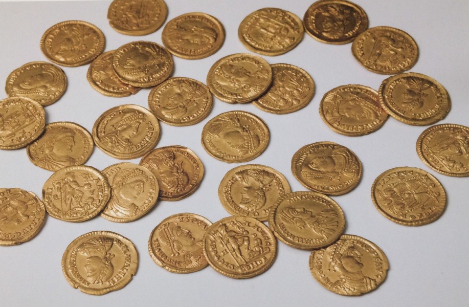 Gold coins scattered across a surface.