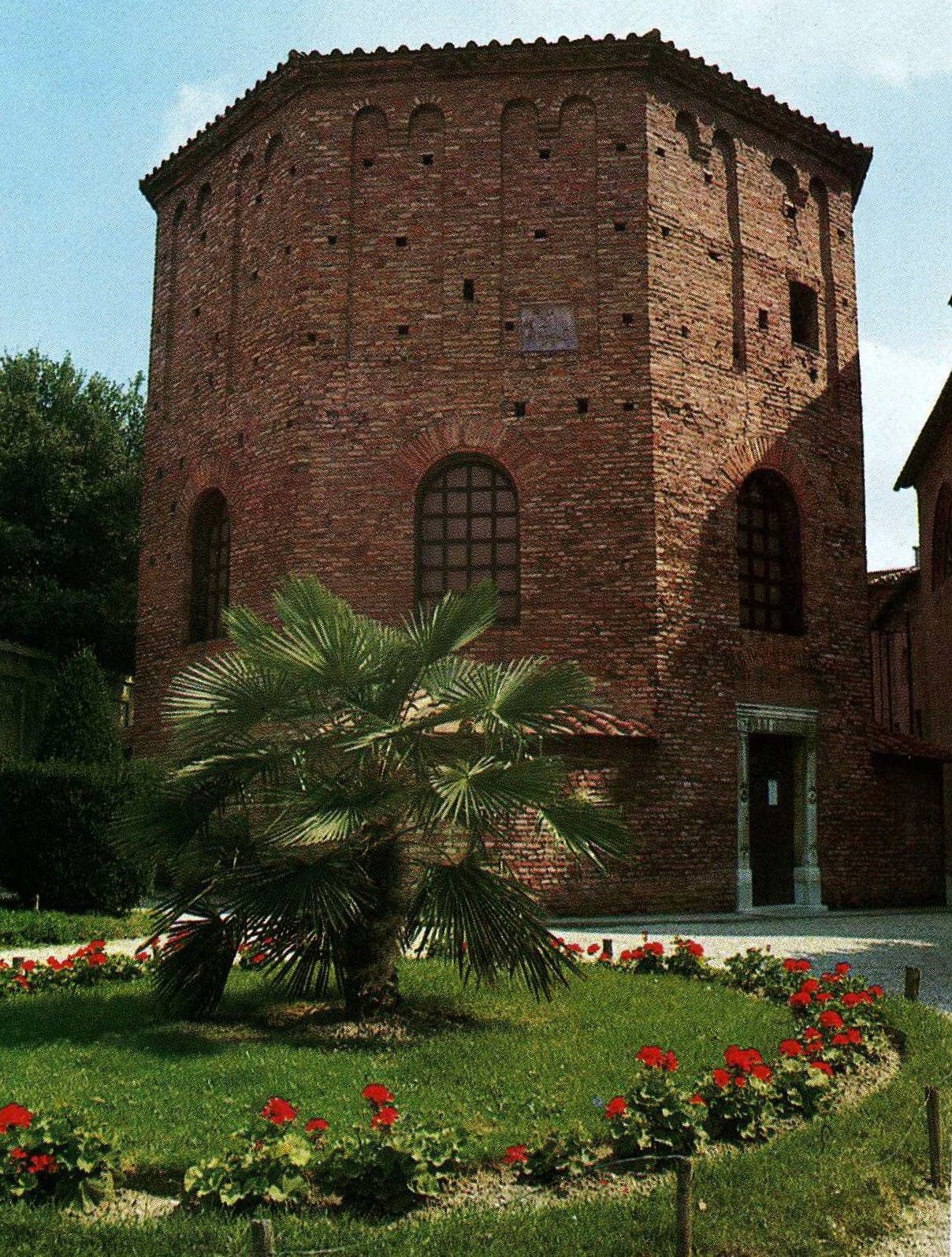 An octagonal three-story high brick building with arched windows on the second story.