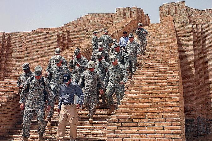 A view of men in military uniforms marching down the central ramp. The ramp easily accommodates four people side by side.