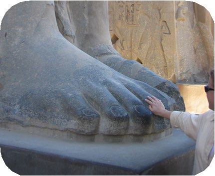 A person dwarfed by the feet of Ramses’ colossus.