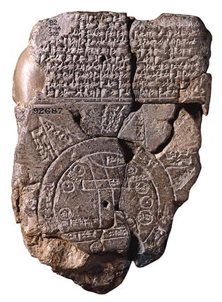 A map carved onto a stone with cuneiform writing around it.