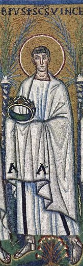 A man in white holding a crown, wearing sandals and standing in front of palm trees.