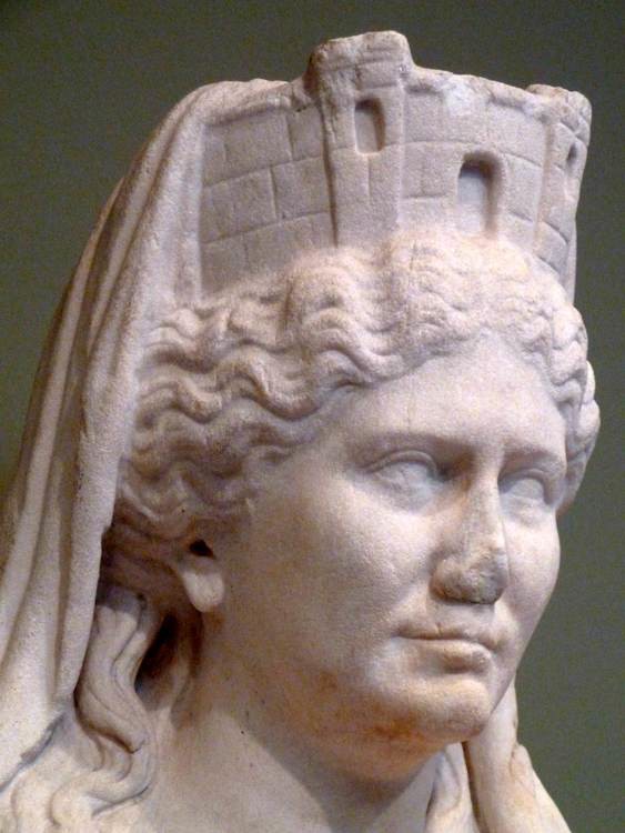 A marble carving of the head of a woman with a crown shaped like fortress walls.