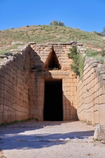 A triangle-shaped stone arch formed by placing stones closer together as they move toward the top. The arch is over a rectangular door opening.