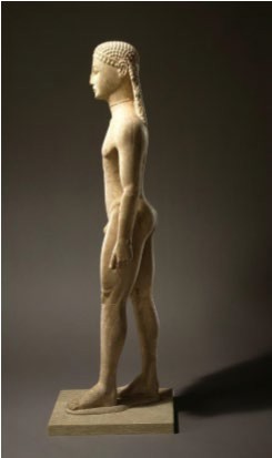 The side view of a nude kouros statue with plaited hair.