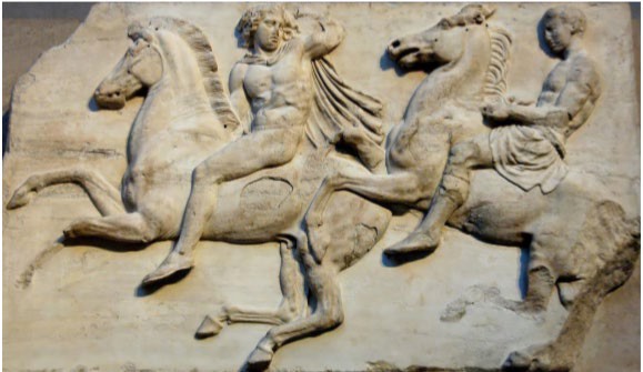Two Greek horsemen are shown in bas relief. The one in front is nude and has a face associated with Apollo.