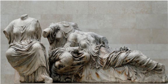 Three now headless carved goddesses recline to fit into the pediment.