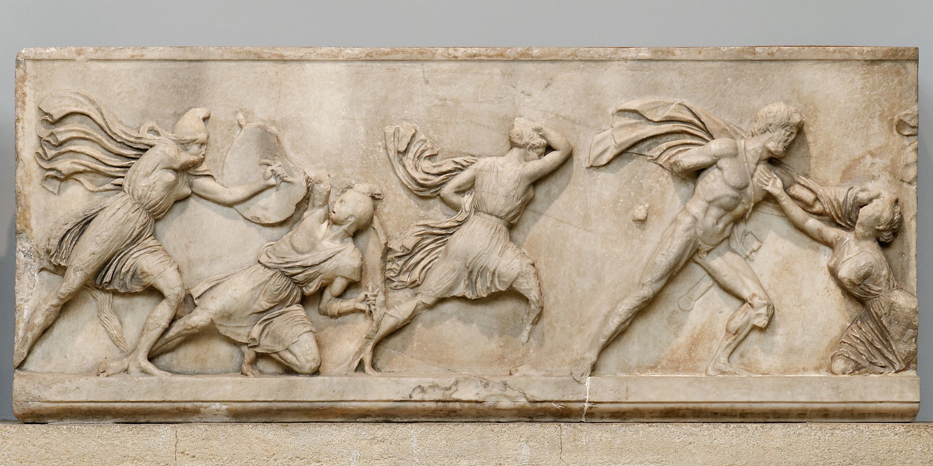 A bas relief of men and women in battle.
