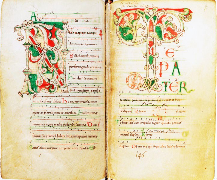 Red and green title letters with Latin writing beside and below them. More importantly, musical notes are included on a staff much like that seen in modern notation.
