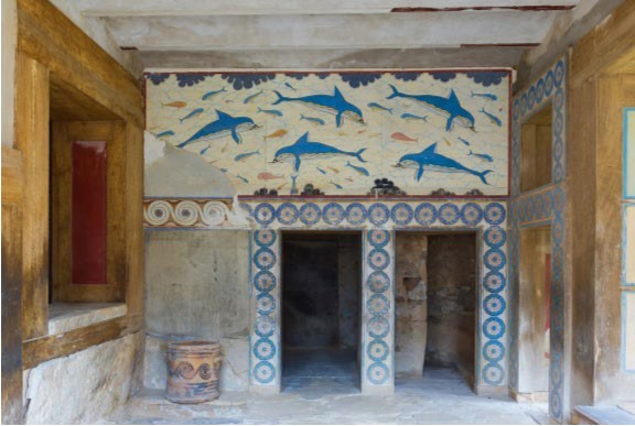 A room with a dolphin fresco covering the upper part and geometric designs around the doorways.