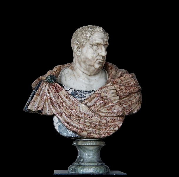A marble bust of a hefty old man with carved and painted cloth draped around and pinned to his shoulders.