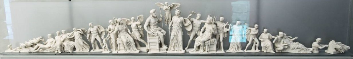 A recreation of the east pediment of the Parthenon. In the center, Zeus welcomes the fully grown Athena as Nike hovers over them. Other gods surround them.
