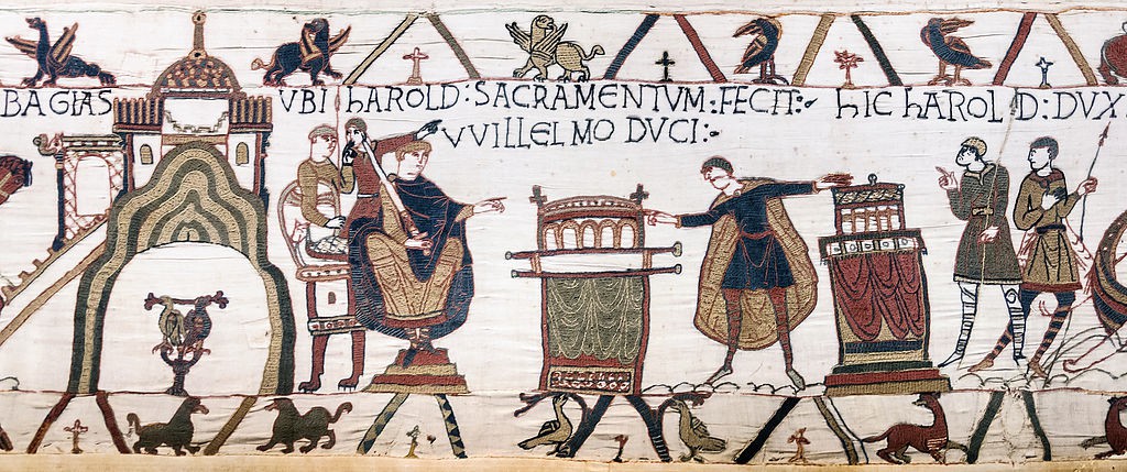 A view of an embroidered linear story with symbols above and below the main story panel. This portion depicts the oath of fealty. Refer to the text for details.