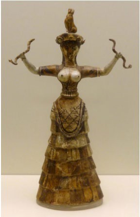 A sculpture of a bare-breasted woman in a large skirt, holding a snake in each hand.