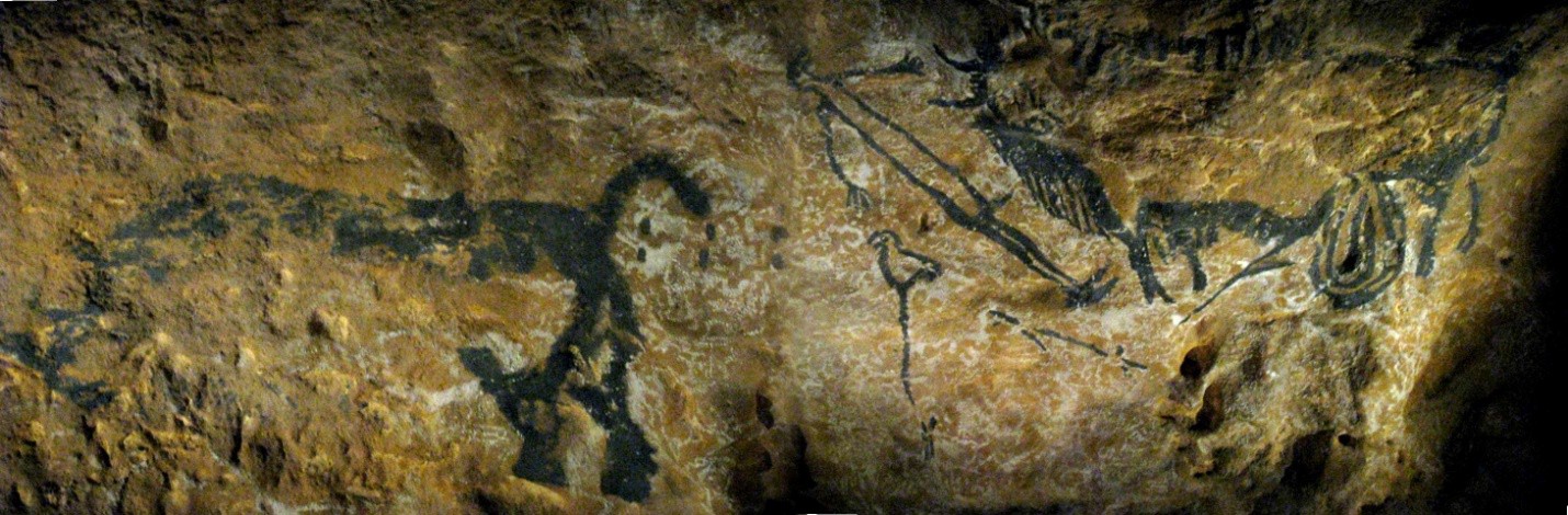 Cave drawing of a man at a well, a bison, and a rhinoceros.